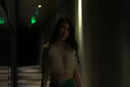 A young lady with thick pubic hair is live streaming. She is wearing a sexy maid outfit with big tits and a plump butt.